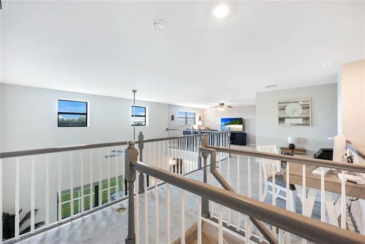 Corridor with plenty of natural light and carpet flooring