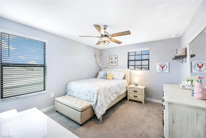 Bedroom featuring ceiling fan and light carpet