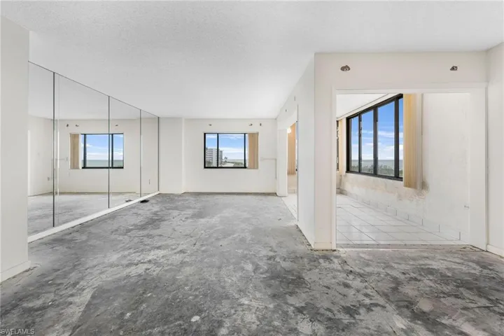 Unfurnished living room with a wealth of natural light and a textured ceiling