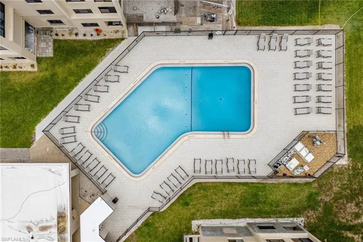View of swimming pool with a lawn