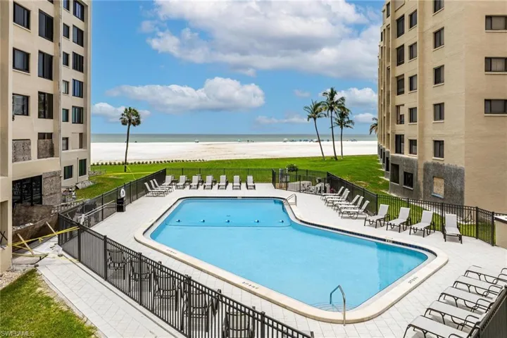 View of pool with a patio area and a water view