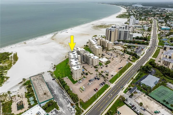 Drone / aerial view with a water view and a beach view