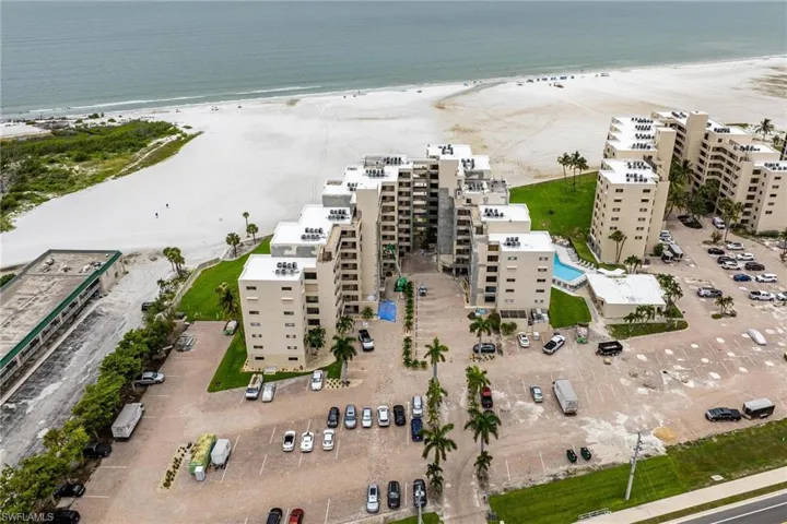 Drone / aerial view featuring a beach view and a water view