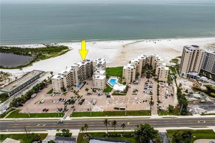 Drone / aerial view featuring a beach view and a water view
