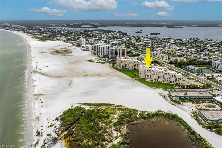Birds eye view of property with a water view
