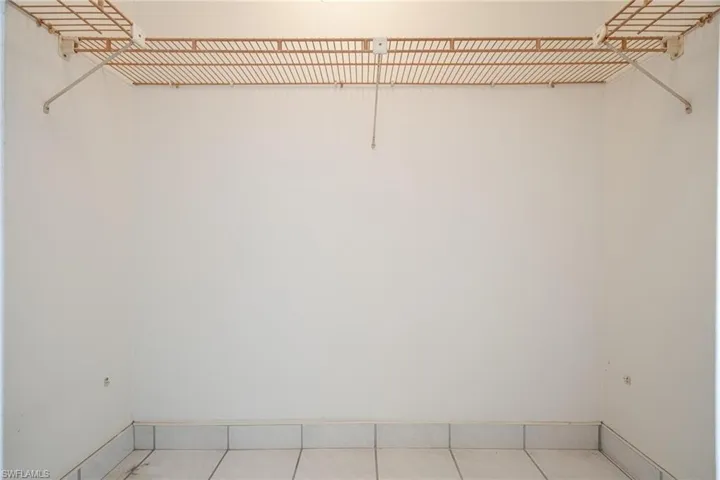 Walk in closet with tile patterned flooring