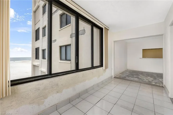 Corridor with a water view and light tile patterned floors