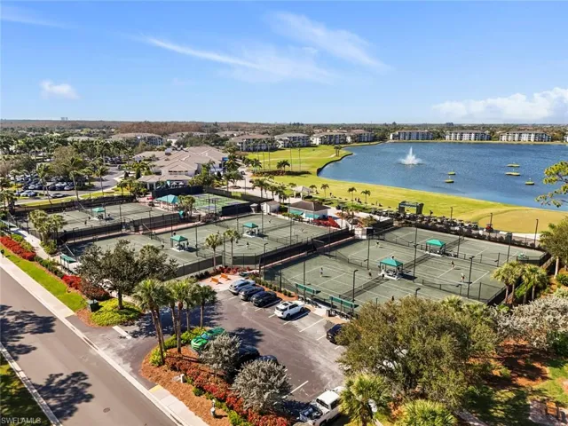Aerial view of the tennis and pickle ball courts with the driving range and island holes in the back ground