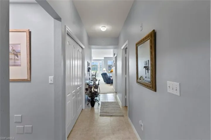 Entrance to your beautiful condo with view of the Lake and golf course in the distance.  The guest bedrrom and bathroom on your left and Primary bedroom on the right.