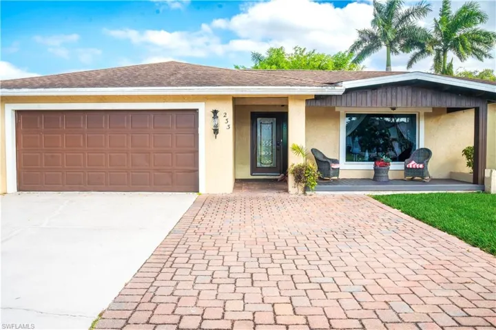 Single story home featuring stucco siding, driveway, a shingled roof, and an attached garage