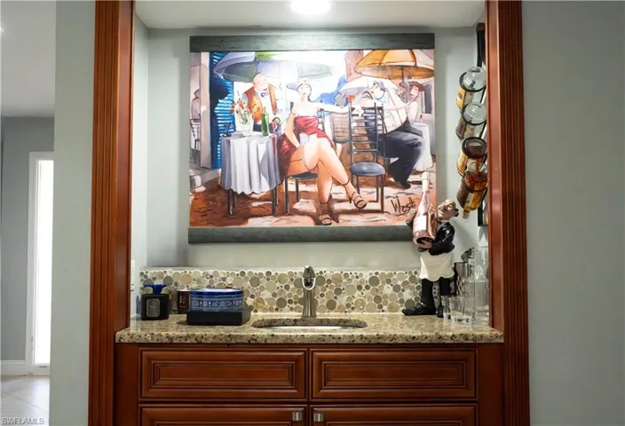 Bar with a sink and light stone counters