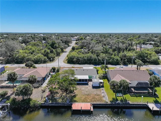 Waterfront property featuring a private dock, direct canal access, and ample green space