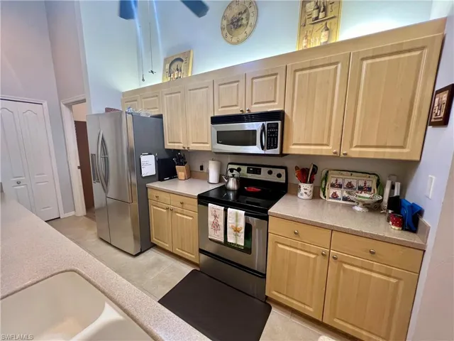 Kitchen featuring light tile patterned flooring,  and stainless steel appliances