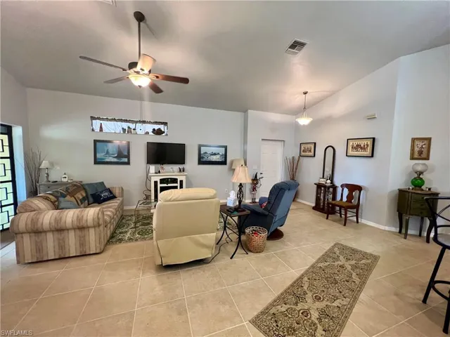 Tiled living room featuring ceiling fan