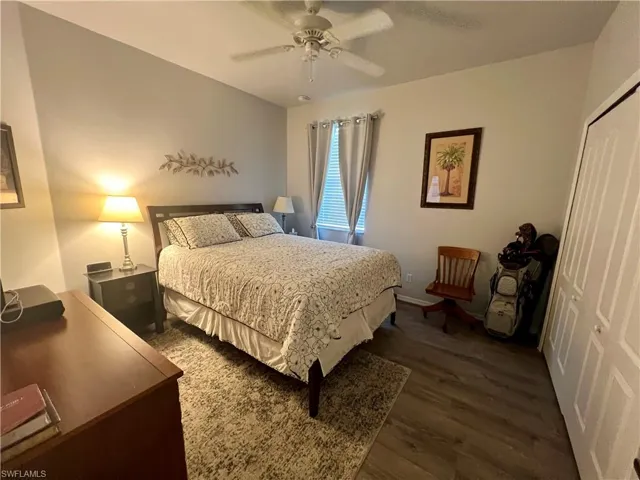 Bedroom with ceiling fan, a closet, and LVP wood-style flooring