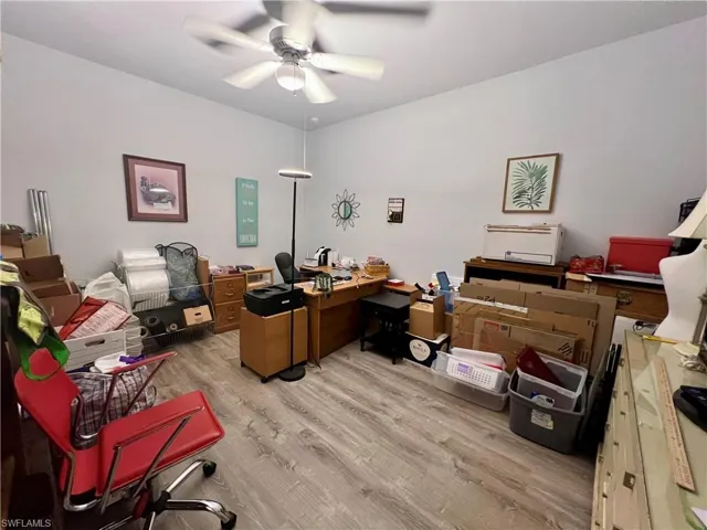 Office space with ceiling fan and LVP  wood-style flooring