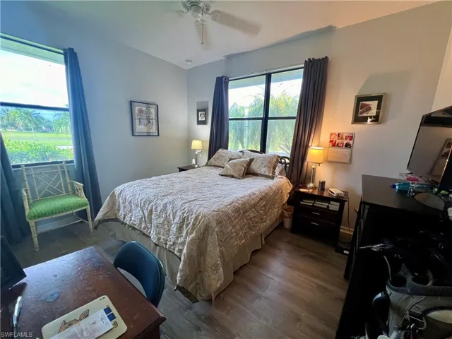 Bedroom with ceiling fan and LVP wood-style flooring