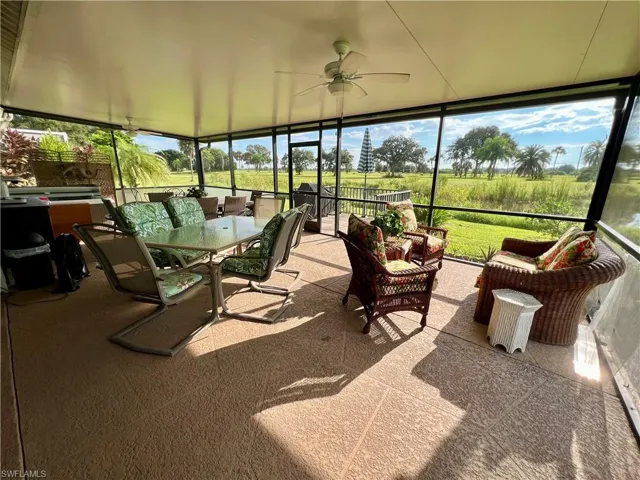 Sunroom / solarium featuring ceiling fan and a healthy amount of sunlight