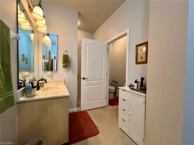 Bathroom with tile patterned floors, vanity, and toilet
