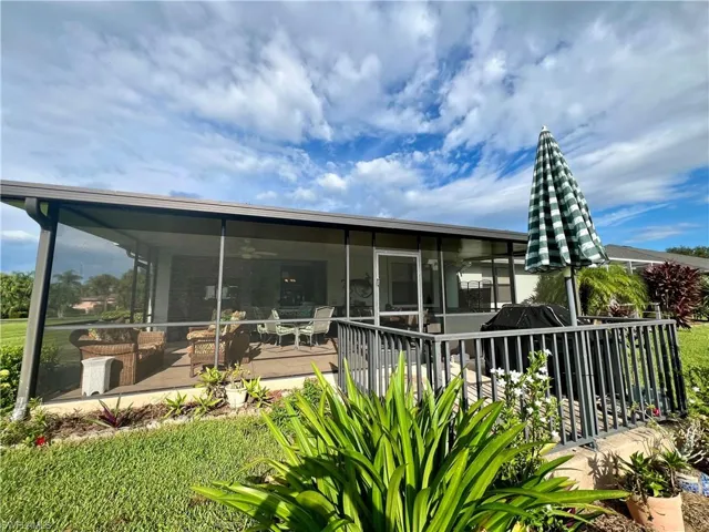 Back of property with a sunroom