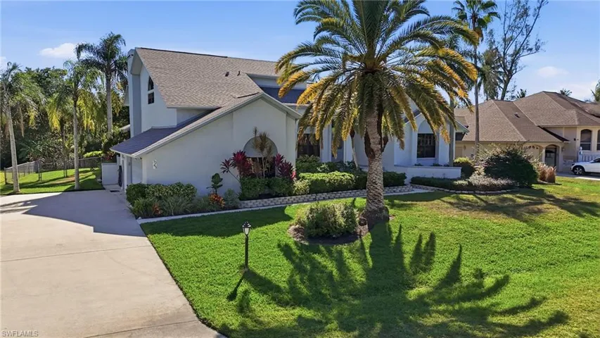 View of front of property featuring concrete driveway, stucco siding, and roof with shingles