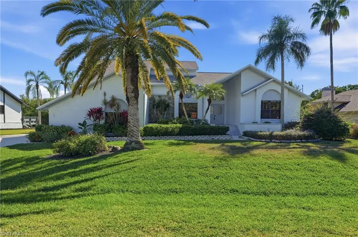 View of front of property featuring stucco siding and a front lawn