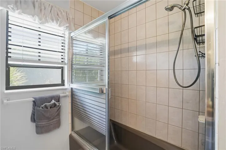 Full bathroom with a shower stall