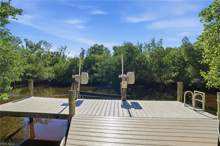 Dock area featuring view of wooded area