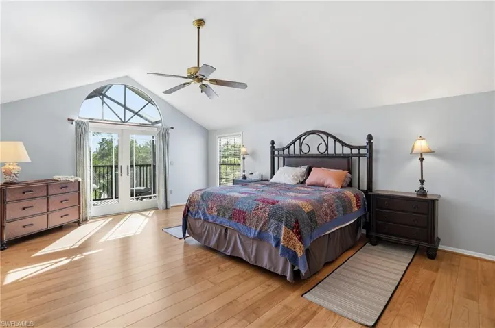 Bedroom with light wood-style floors, access to exterior, french doors, a ceiling fan, and high vaulted ceiling