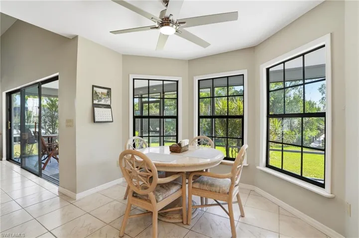Dining area with plenty of natural light, a ceiling fan, and light tile patterned floors