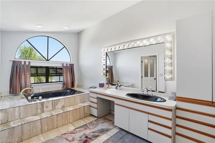 Full bath with a garden tub and vanity