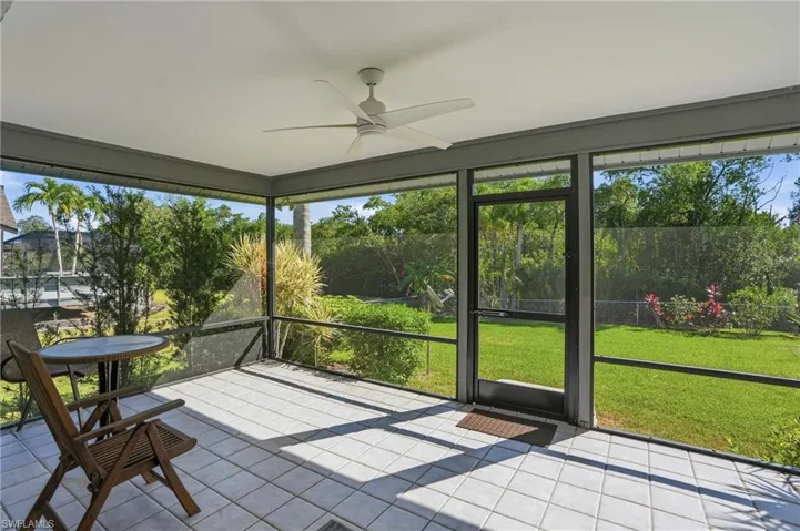 Unfurnished sunroom featuring a ceiling fan