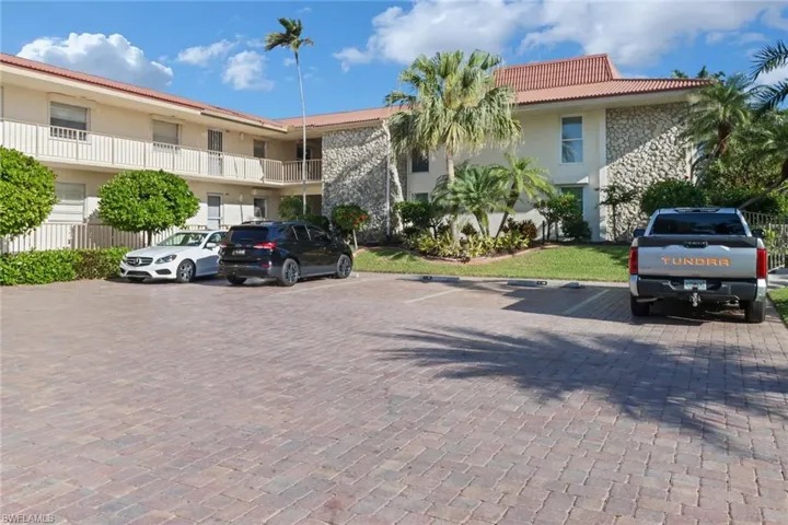 View of property featuring uncovered parking