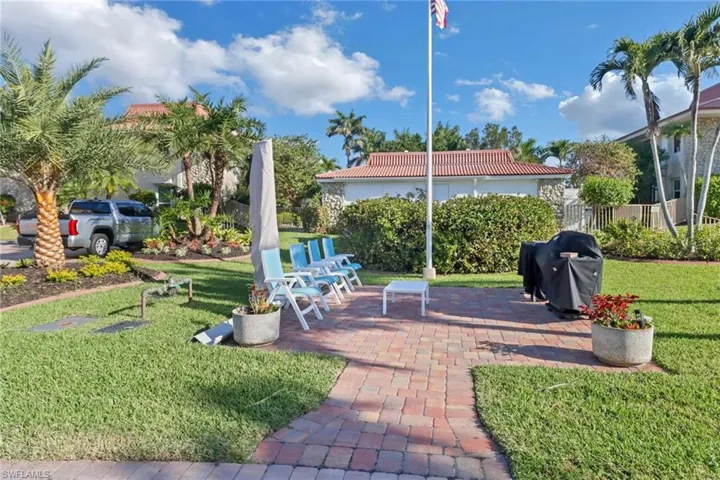 View of yard featuring fence and a patio