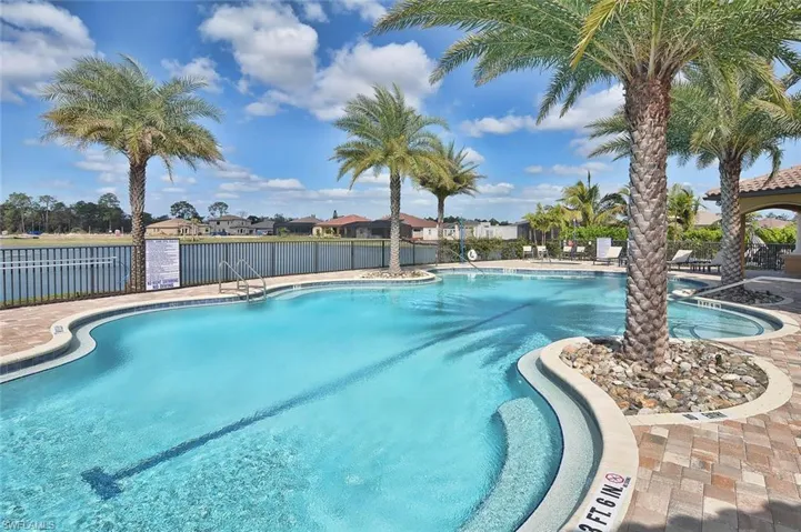 Community pool with a patio and a residential view