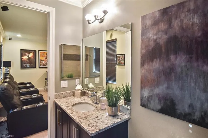 Bathroom with vanity and ornamental molding