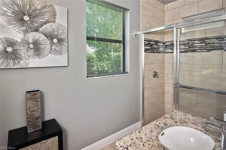 Bathroom with vanity and a shower stall