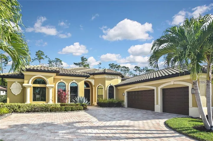 Mediterranean / spanish-style home with decorative driveway, a garage, stucco siding, and a tile roof