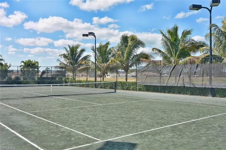 View of tennis court with community basketball court