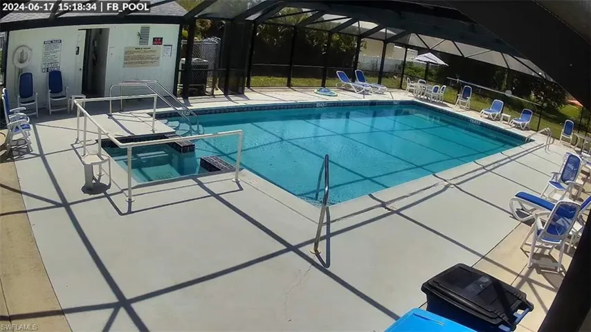View of community swimming pool with a patio