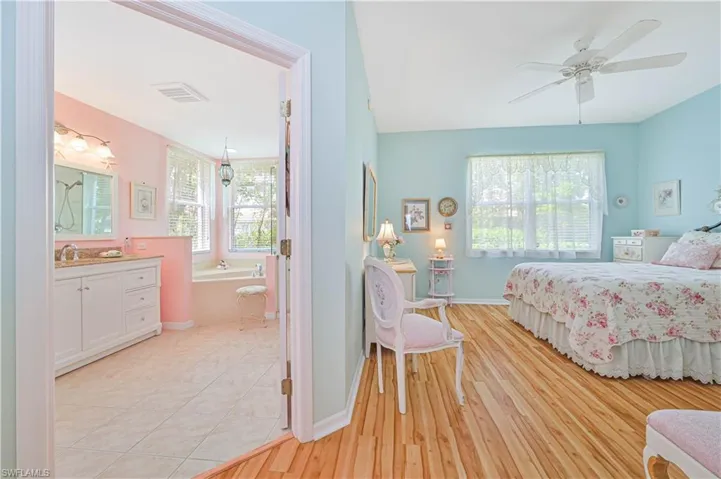 Master bedroom featuring sink, connected bathroom, and ceiling fan