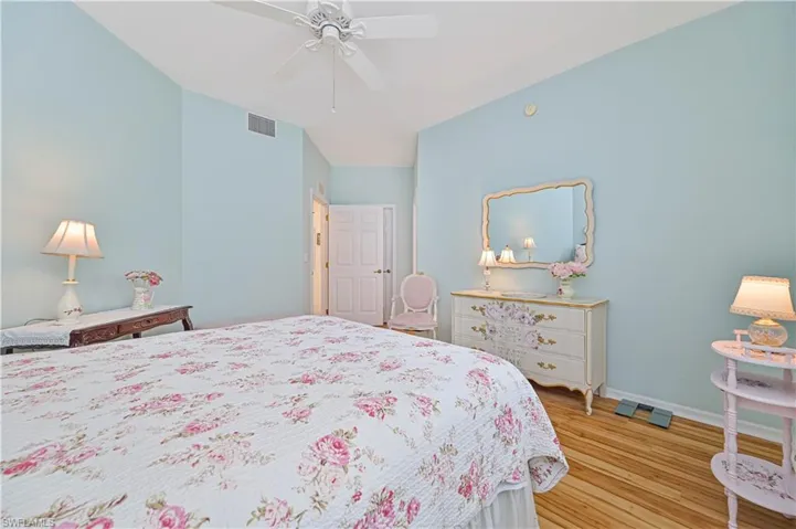 Bedroom featuring ceiling fan, light hardwood / wood-style floors, and lofted ceiling