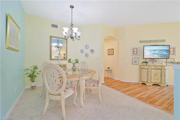 Dining space with an inviting chandelier and hardwood / wood-style floors