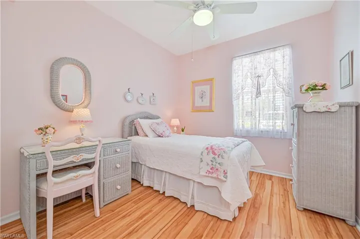 Bedroom with ceiling fan and light hardwood / wood-style flooring
