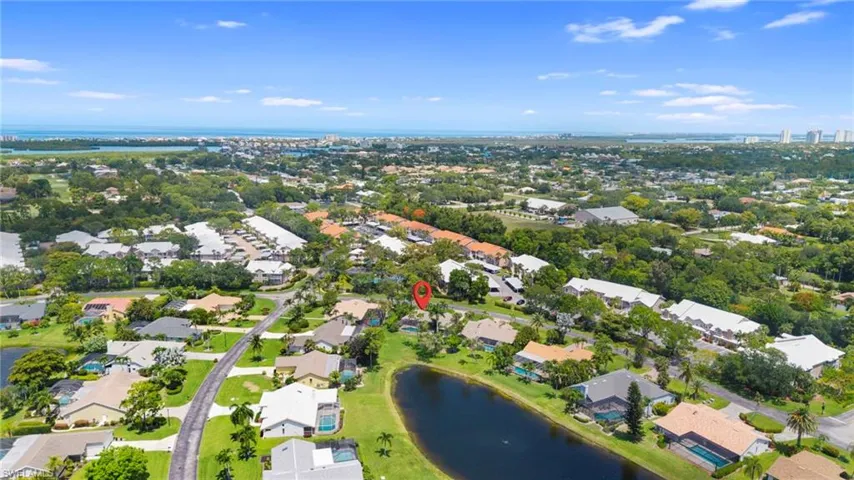 Aerial perspective highlighting a residential neighborhood with a prominent body of water