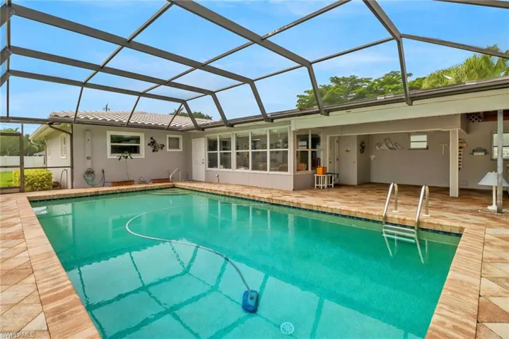 View of pool with a patio and a lanai