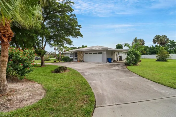 Ranch-style house with a front lawn and a garage