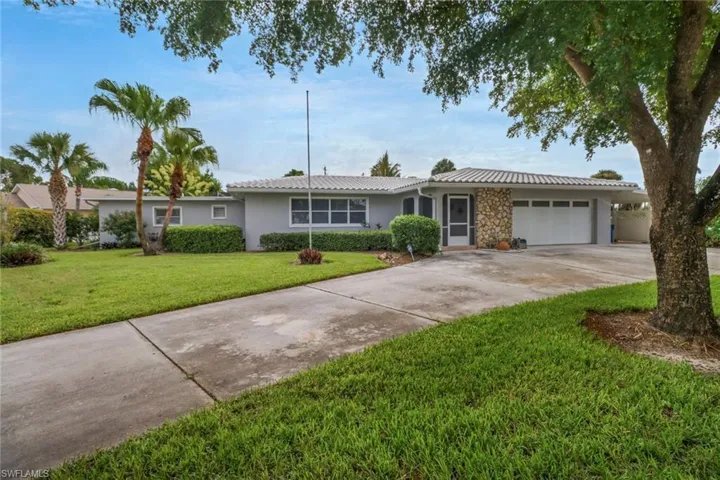 Ranch-style house with a garage and a front yard