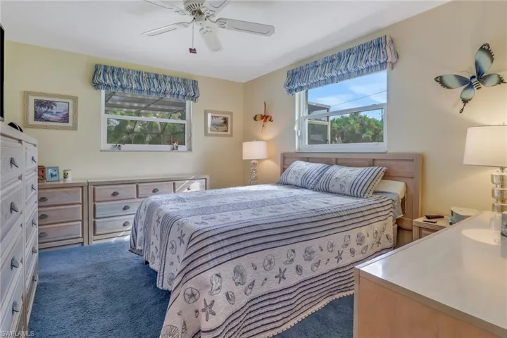 Bedroom with ceiling fan and carpet floors