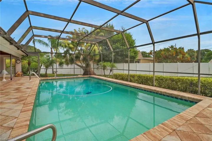 View of pool featuring glass enclosure
